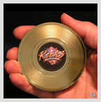 hand holding mini gold record magnet